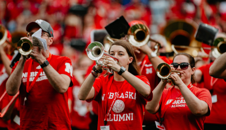 Alumni band members playing trumpet